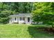 Charming home with well-maintained lawn and inviting porch, perfect for relaxing outdoors at 725 E Maple Ln, Fuquay Varina, NC 27526