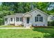 Charming home with a well-manicured lawn, blue shutters and an inviting front porch at 725 E Maple Ln, Fuquay Varina, NC 27526