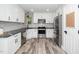 Stylish kitchen featuring stainless steel appliances, white cabinets and subway tile backsplash at 725 E Maple Ln, Fuquay Varina, NC 27526