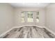 Bright living area with large bay window and stylish flooring at 725 E Maple Ln, Fuquay Varina, NC 27526