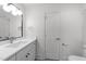 Well-lit bathroom featuring a vanity with stone countertop and undermount sink at 807 Edmund St, Raleigh, NC 27604