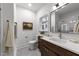 Well-lit bathroom with stylish vanity, framed mirror, and neutral color palette at 807 Edmund St, Raleigh, NC 27604