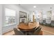 Inviting dining area with fireplace, hardwood floors, and views to kitchen at 807 Edmund St, Raleigh, NC 27604