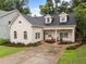Charming home boasts a well-manicured lawn, brick-lined drive, and inviting front porch at 807 Edmund St, Raleigh, NC 27604