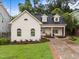 Charming home boasts a well-manicured lawn, brick-lined drive, and inviting front porch at 807 Edmund St, Raleigh, NC 27604