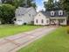 A charming home featuring a long, patterned driveway, a covered front porch, and curb appeal at 807 Edmund St, Raleigh, NC 27604