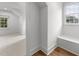Bright hallway with hardwood floors, a built-in bench, and windows providing natural light at 807 Edmund St, Raleigh, NC 27604