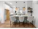 Bright kitchen featuring an island with seating, quartz countertops and pendant lighting at 807 Edmund St, Raleigh, NC 27604