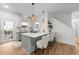 Open kitchen boasts an island with seating, modern appliances, and sleek countertops at 807 Edmund St, Raleigh, NC 27604