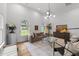 Bright living room features hardwood floors, many windows, high ceilings, and stylish decor at 807 Edmund St, Raleigh, NC 27604