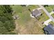 Aerial view of a well-maintained lawn in a fenced-in backyard of the house with other outbuildings on the property at 85 Twelve Oaks Dr, Willow Springs, NC 27592