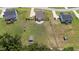 Aerial view of a well-maintained lawn in a fenced-in backyard of the house with other outbuildings on the property at 85 Twelve Oaks Dr, Willow Springs, NC 27592
