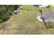 Aerial view of a well-maintained lawn in a fenced-in backyard of the house with other outbuildings on the property at 85 Twelve Oaks Dr, Willow Springs, NC 27592