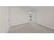 Bedroom with neutral walls and carpet, featuring a door and ample natural light at 85 Twelve Oaks Dr, Willow Springs, NC 27592