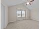 Cozy bedroom featuring a vaulted ceiling, ceiling fan and a large window at 85 Twelve Oaks Dr, Willow Springs, NC 27592