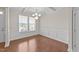 Bright dining room boasts a coffered ceiling, elegant chandelier, and wainscoting at 85 Twelve Oaks Dr, Willow Springs, NC 27592