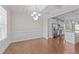 Bright dining room features wainscoting, hardwood floors, and a view into the kitchen at 85 Twelve Oaks Dr, Willow Springs, NC 27592