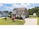 Well-maintained home boasts an attached garage and long driveway at 85 Twelve Oaks Dr, Willow Springs, NC 27592