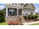 Beautiful home featuring a welcoming front porch and well-maintained landscaping at 85 Twelve Oaks Dr, Willow Springs, NC 27592