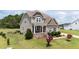 Beautiful two-story home with a covered front porch and stone accents at 85 Twelve Oaks Dr, Willow Springs, NC 27592