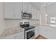 Modern kitchen features stainless steel appliances, subway tile backsplash, and granite countertops at 85 Twelve Oaks Dr, Willow Springs, NC 27592