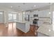 Open-concept kitchen features granite countertops, stainless steel appliances, and a large island at 85 Twelve Oaks Dr, Willow Springs, NC 27592