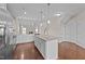 Kitchen with stainless appliances, granite countertops, and kitchen island with pendant lights at 85 Twelve Oaks Dr, Willow Springs, NC 27592