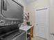 Laundry room equipped with a stacked washer and dryer unit, plus workspace at 85 Twelve Oaks Dr, Willow Springs, NC 27592