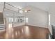 Open-concept living room showcasing hardwood floors, a high ceiling, and seamless connection to the kitchen at 85 Twelve Oaks Dr, Willow Springs, NC 27592