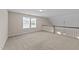 Cozy loft area with neutral carpet, natural light, and a view of the front yard at 85 Twelve Oaks Dr, Willow Springs, NC 27592