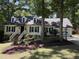 Charming home with dormer windows, black shutters, landscaped yard, and brick walkway at 8629 Windjammer Dr, Raleigh, NC 27615