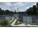 Outdoor community tennis courts surrounded by fences and greenery at 8629 Windjammer Dr, Raleigh, NC 27615