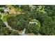 Expansive aerial view of a secluded home nestled amongst lush trees and greenery at 9 Piney Grove Rd, Bahama, NC 27503