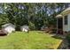 Lush backyard featuring a shed, mature trees, and a well-maintained lawn at 9 Piney Grove Rd, Bahama, NC 27503