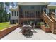 Charming backyard with a patio area, screened porch, and lush greenery at 9 Piney Grove Rd, Bahama, NC 27503