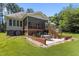 Beautiful backyard featuring a patio, screened porch, and a well-maintained lawn at 9 Piney Grove Rd, Bahama, NC 27503