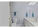 Bathroom featuring vanity with sink, a toilet, towel racks, and a shower behind a door at 9 Piney Grove Rd, Bahama, NC 27503