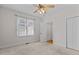 Neutral bedroom featuring a ceiling fan, window, and double door closet, offering a serene living space at 9 Piney Grove Rd, Bahama, NC 27503