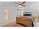 Bedroom featuring a bed, ceiling fan, nightstands, and doorway to an ensuite bathroom at 9 Piney Grove Rd, Bahama, NC 27503