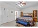 Bedroom featuring a bed, bench, nightstand, ceiling fan, and doorway to an ensuite bathroom at 9 Piney Grove Rd, Bahama, NC 27503