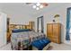 Bedroom featuring a bed, bench, storage cabinet, ceiling fan, and window with curtains at 9 Piney Grove Rd, Bahama, NC 27503