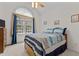 Bright bedroom with a large window, ceiling fan, and comfortable bed with blue accents at 9 Piney Grove Rd, Bahama, NC 27503