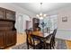 Elegant dining room featuring a chandelier, wooden table, and an adjacent room with bright natural light at 9 Piney Grove Rd, Bahama, NC 27503