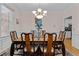 Elegant dining room with a chandelier, a beautiful table and chairs set, and natural light at 9 Piney Grove Rd, Bahama, NC 27503
