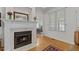 Elegant fireplace with marble surround and view of dining room with chandelier at 9 Piney Grove Rd, Bahama, NC 27503