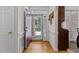 Foyer featuring wood floors, sidelight window, and a view of the home's exterior and front yard at 9 Piney Grove Rd, Bahama, NC 27503