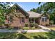 Charming brick home featuring manicured landscaping, red shutters, and a covered front porch at 9 Piney Grove Rd, Bahama, NC 27503