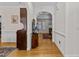 Hallway with wood floors leads to a spacious living area with abundant natural light and an adjacent room at 9 Piney Grove Rd, Bahama, NC 27503