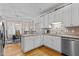 Spacious kitchen with white cabinets, stainless appliances, and adjacent dining area at 9 Piney Grove Rd, Bahama, NC 27503