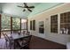 Relaxing screened-in porch featuring an outdoor dining area and ceiling fan at 9 Piney Grove Rd, Bahama, NC 27503
